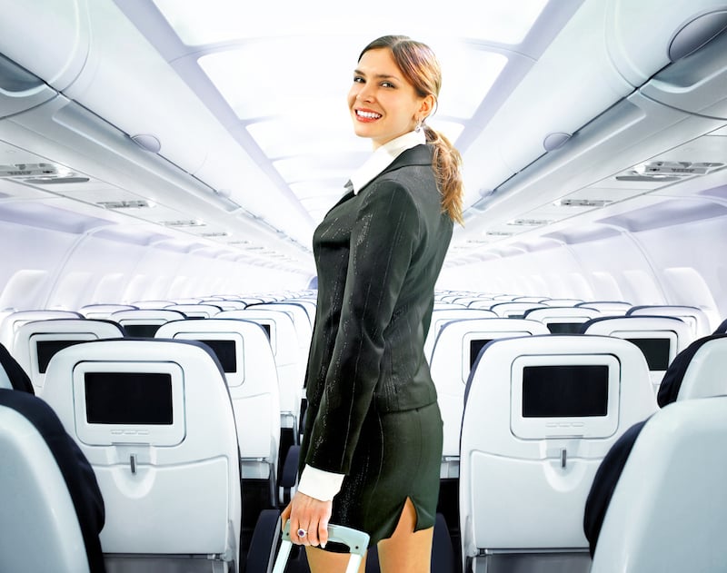 Beautiful flight attendant doing her job on a big plane