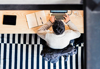 Man writing a chronological resume at his desk